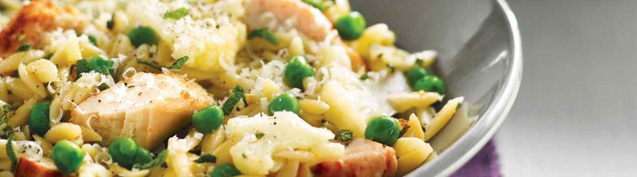 cauliflower, shredded chicken, orzo and herbs in a serving bowl