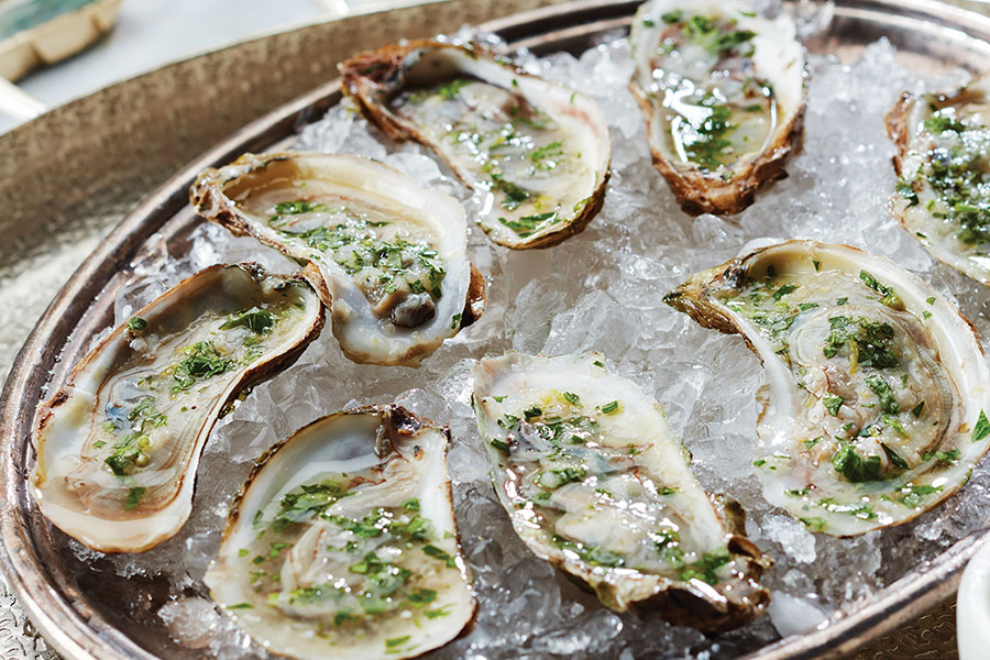 oysters on crushed ice with lemon herb mignonette overtop