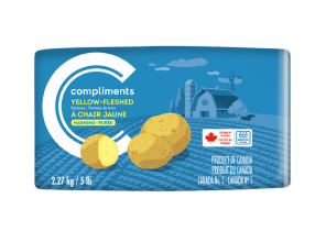 Blue paper bag package of Compliments yellow-fleshed mashing potatoes with a barn illustration.