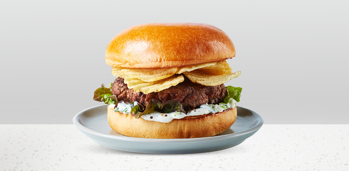 Chip & Dip Burger: Compliments Brioche Hamburger Buns stacked with fresh beef chuck bacon and cheddar or fresh Angus beef burger, Compliments Regular Ripple Potato Chips, red leaf lettuce, and Onion Dip Spread.