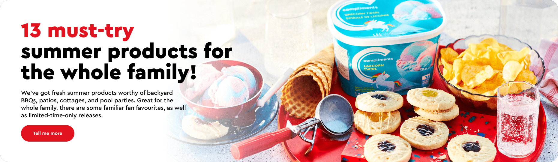 Tabletop with red tray of snacks, including unicorn ice cream, kettle chips, sparkling water and cookies.