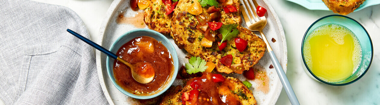 Savoury French toast slices on a beige plate topped with fresh cherry tomato salsa.