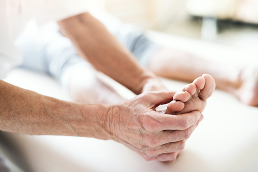 diabetes feet - hands holding foot during diabetes foot check