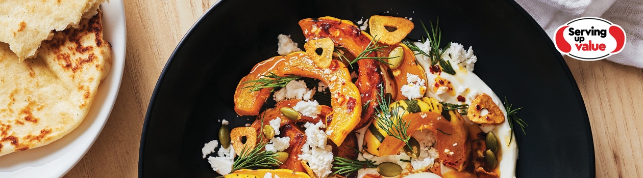 Turkish eggs with squash on dark round scooped plate